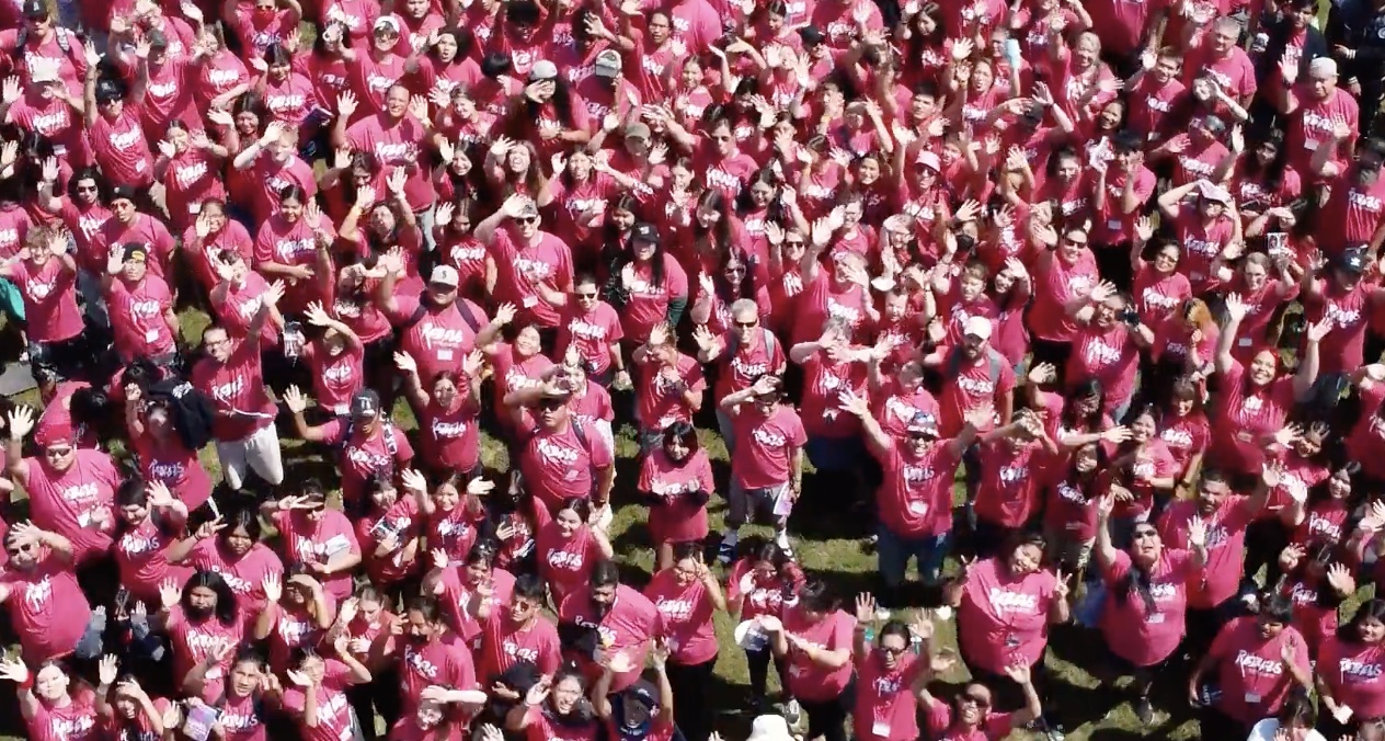 Crowd at On Eagles Wings all wearing pink shirts
