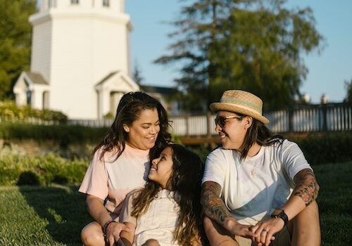 family on lawn by lighthouse, mom, dad and girl