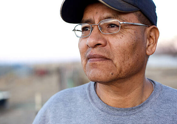 man wearing baseball cap looking off into the distance